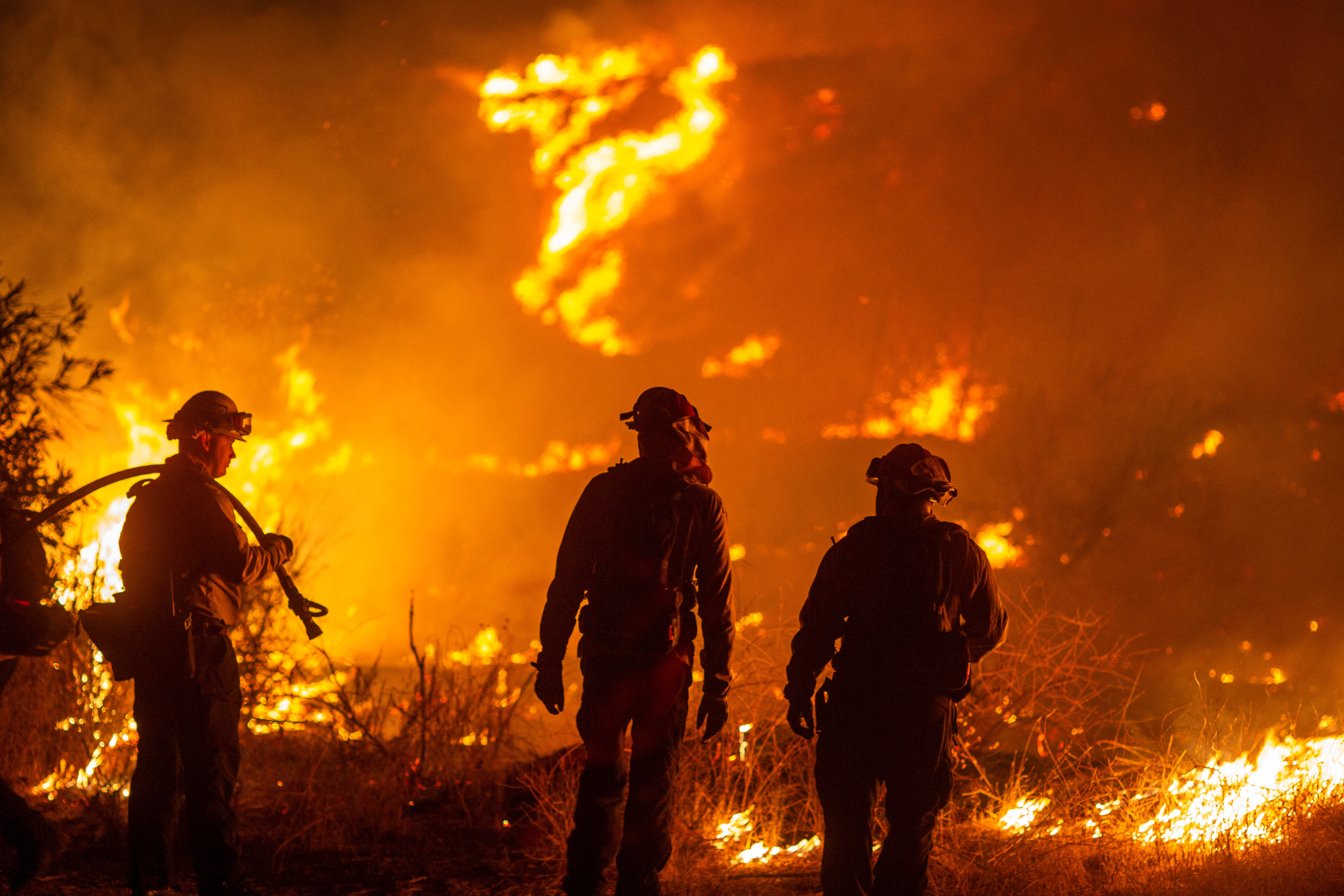 Firefighters and aircraft battle the Hughes Fire near Santa Clarita