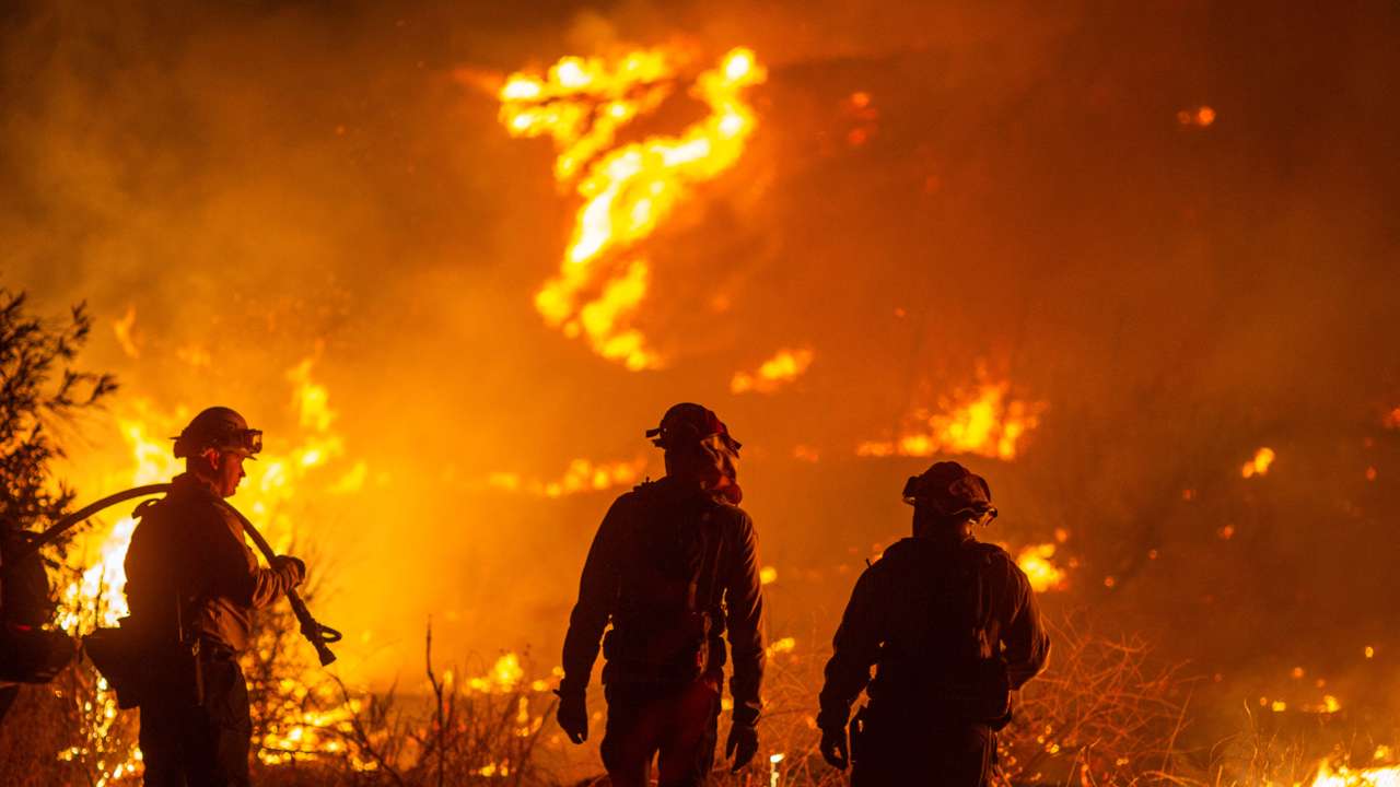 Firefighters and aircraft battle the Hughes Fire near Santa Clarita