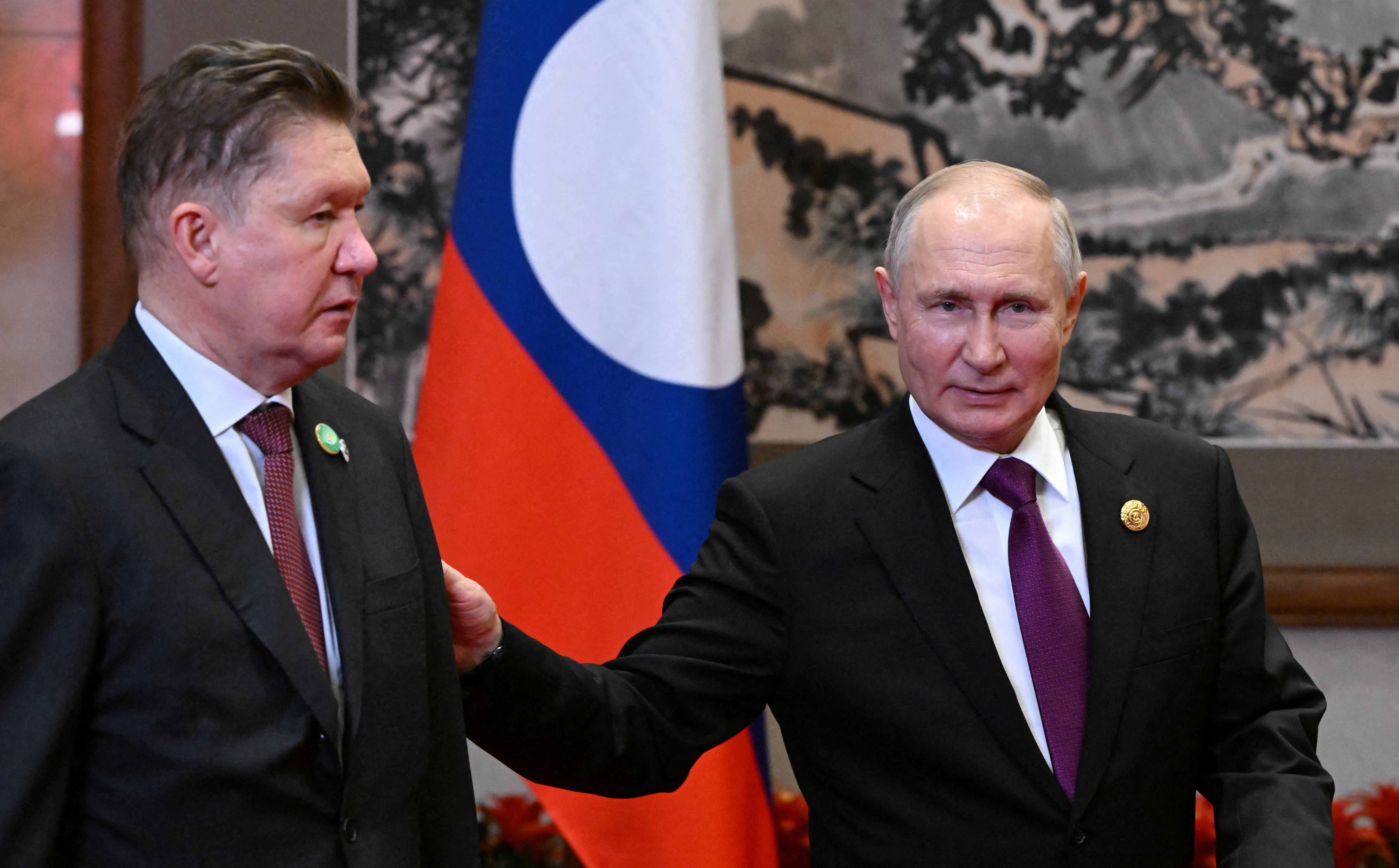 FILE PHOTO: Russian President Vladimir Putin and Lao President Thongloun Sisoulith meet in Beijing