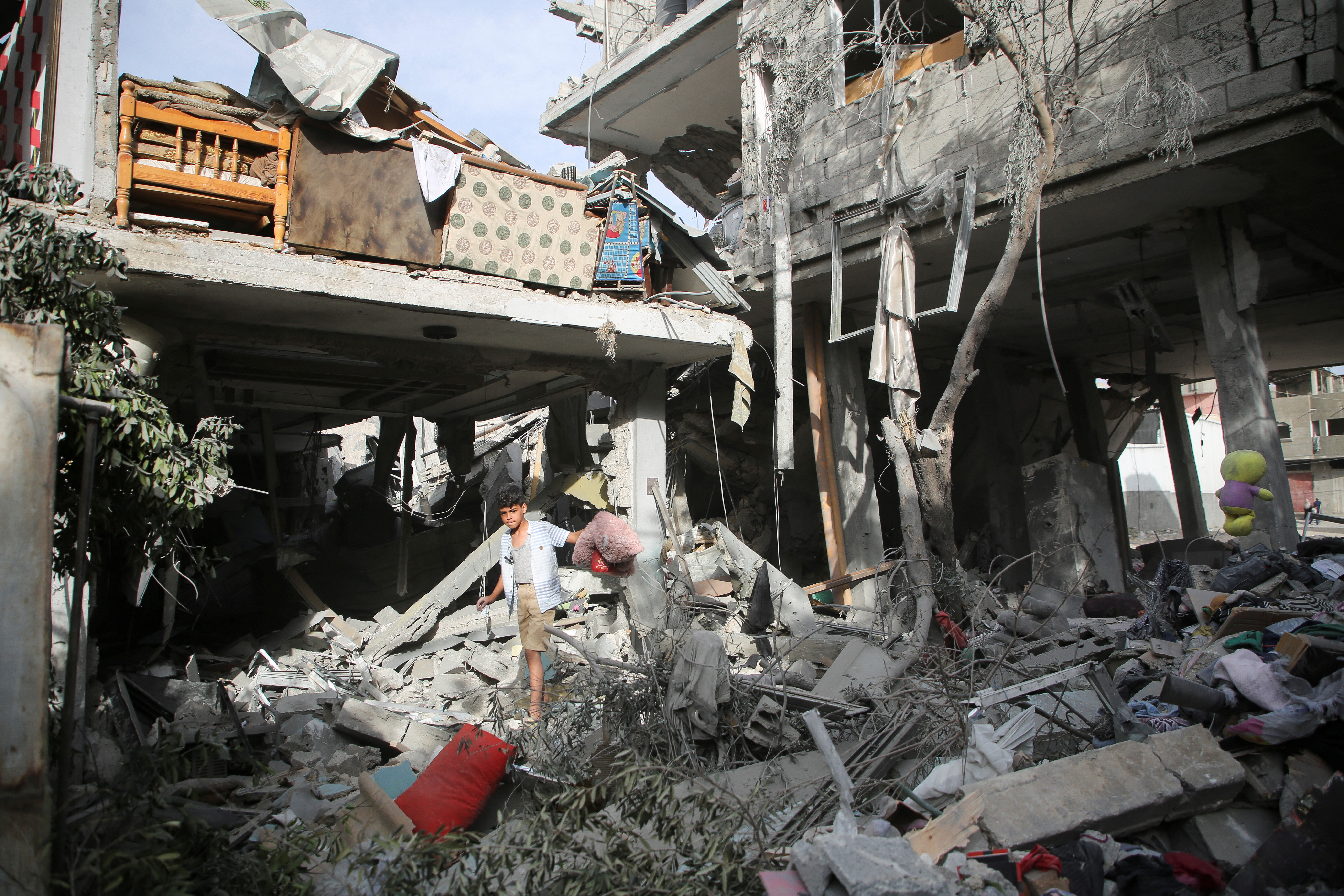 Palestinians inspect the site of an Israeli strike on a house in Rafah