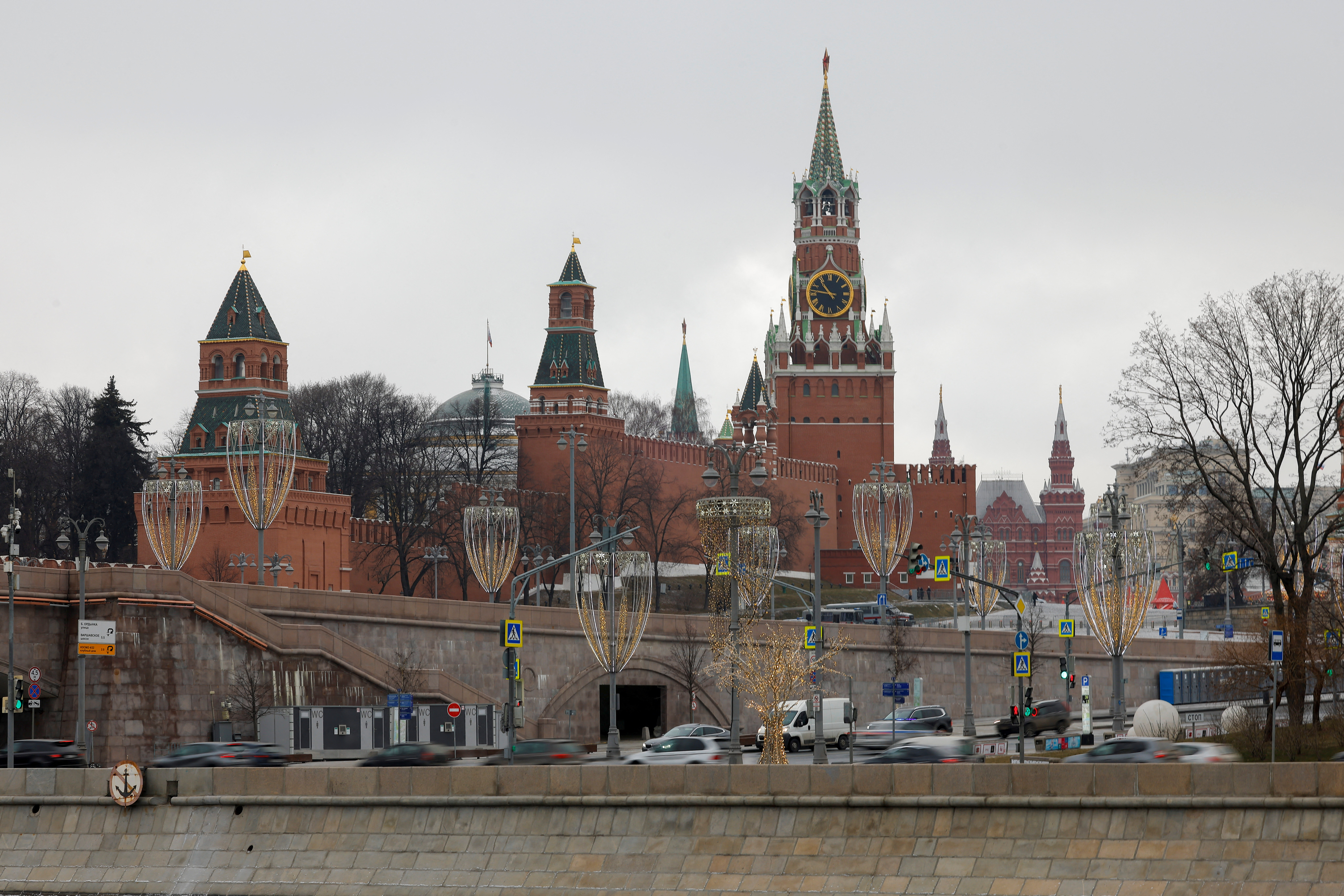Cars drive along an embankment in central Moscow