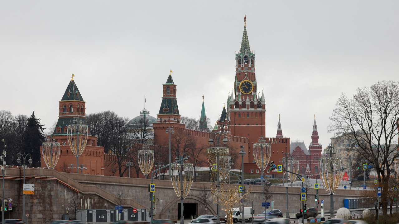 Cars drive along an embankment in central Moscow
