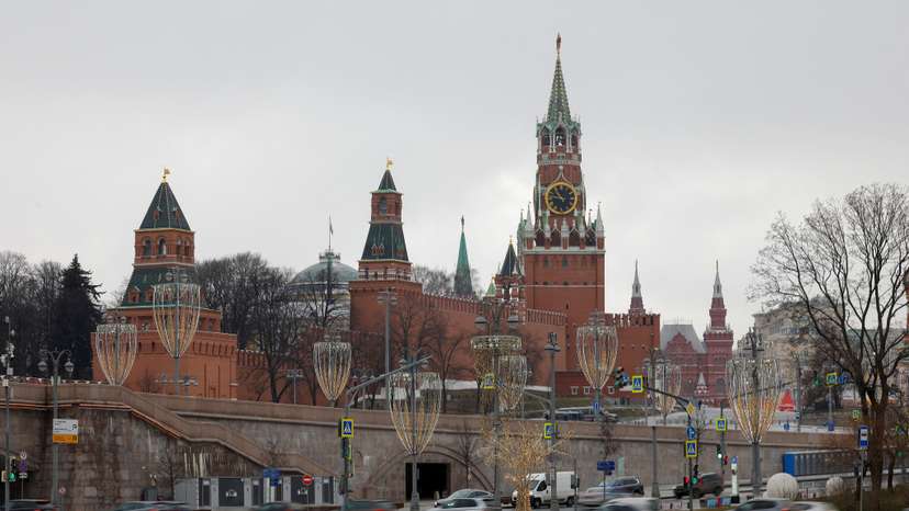 Cars drive along an embankment in central Moscow