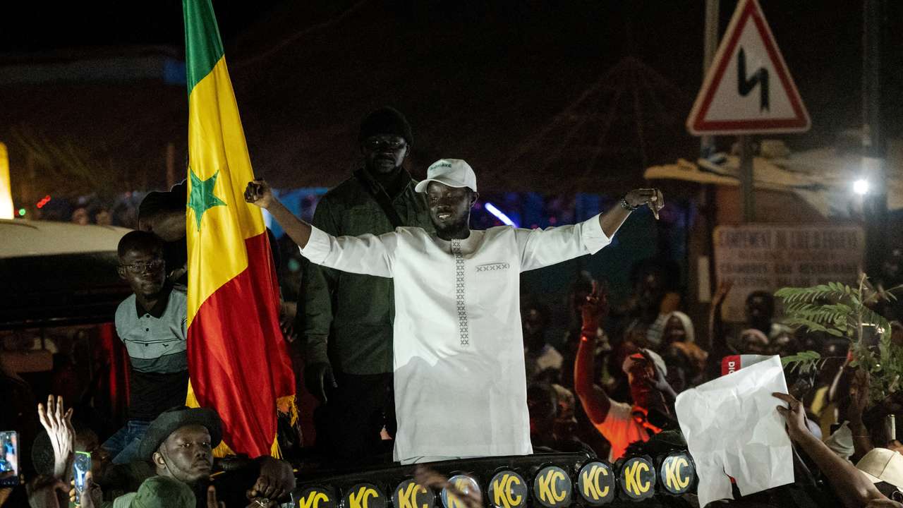 FILE PHOTO: Presidential candidate Bassirou Diomaye Faye cheers on supporters during his electoral campaign caravan in Ziguinchor