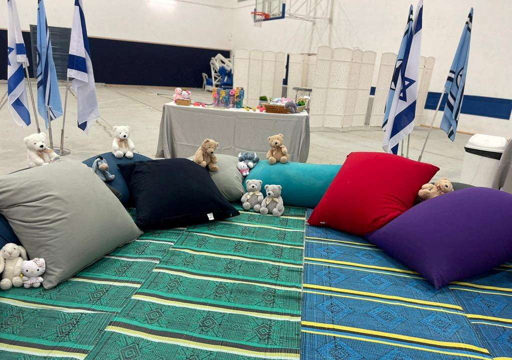Stuffed animals and cushions await the arrival of children who have been held hostage in the Gaza Strip
