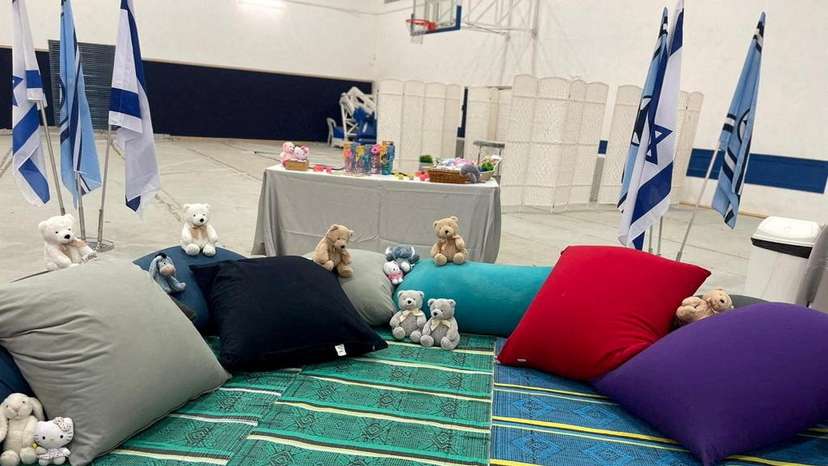 Stuffed animals and cushions await the arrival of children who have been held hostage in the Gaza Strip
