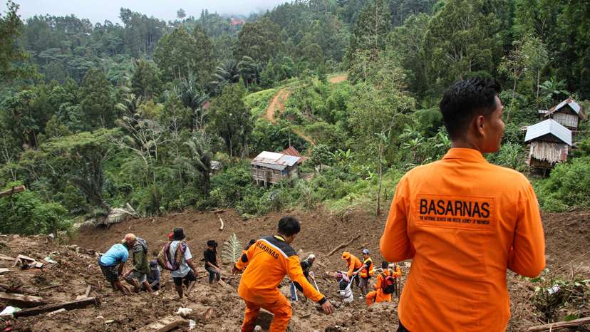 Indonesian rescue members with residents evacuated people from the site of a landslide triggered by high-intensity rains, that affected two villages in Tana Toraja