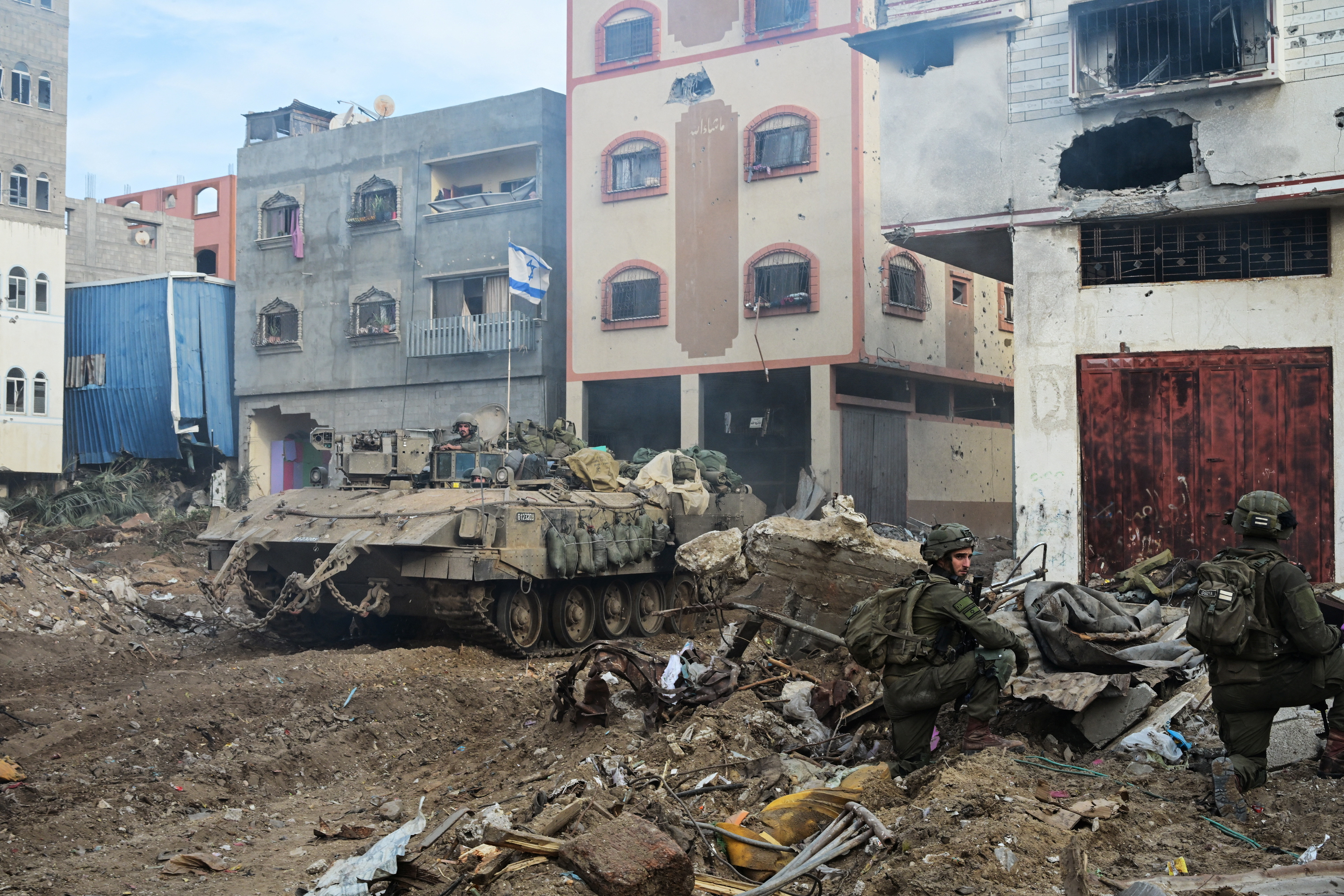 Israeli soldiers operate at the Shajaiya district of Gaza city amid the ongoing conflict between Israel and the Palestinian Islamist group Hamas, in the Gaza Strip