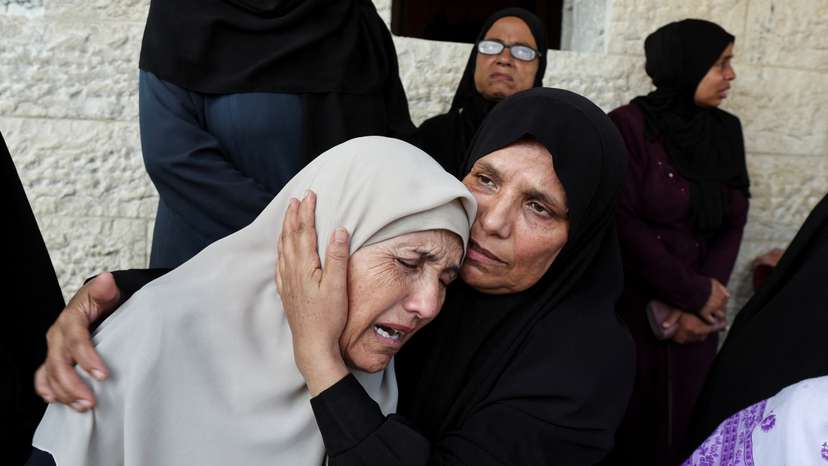 Palestinians mourn loved ones killed in Israeli strikes, in Deir Al-Balah
