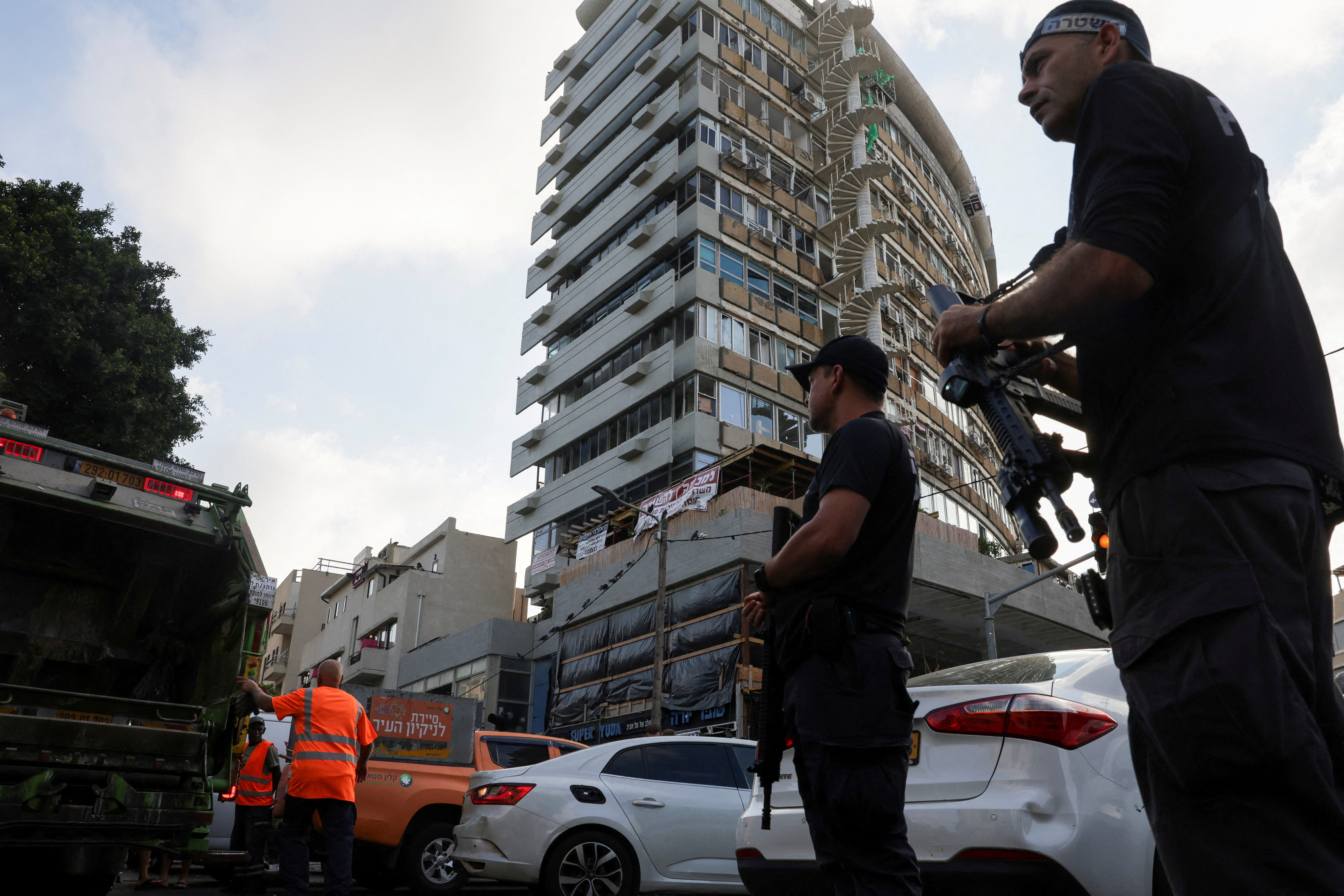 Israelis gather at the site of an explosion amid the Israel-Hamas conflict in Tel-Aviv