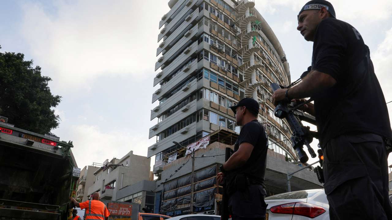 Israelis gather at the site of an explosion amid the Israel-Hamas conflict in Tel-Aviv