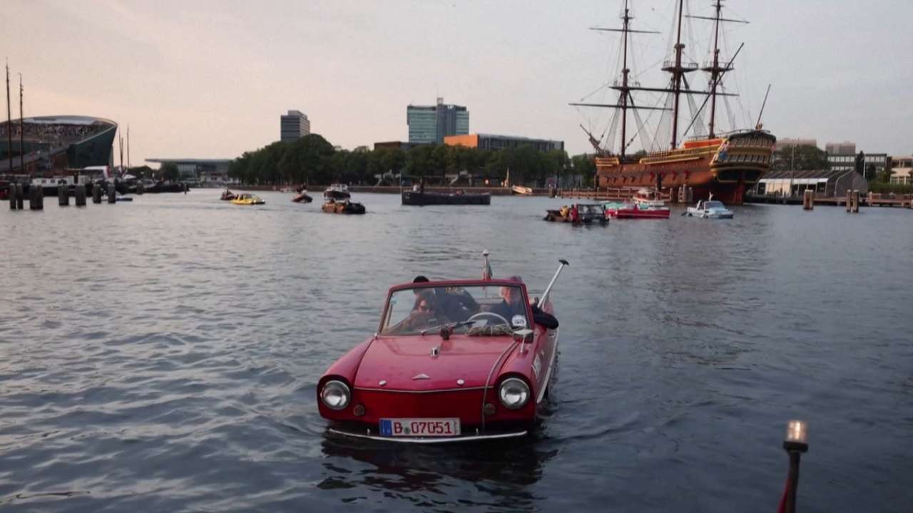 Amphibious vehicles glide through Amsterdam's canals