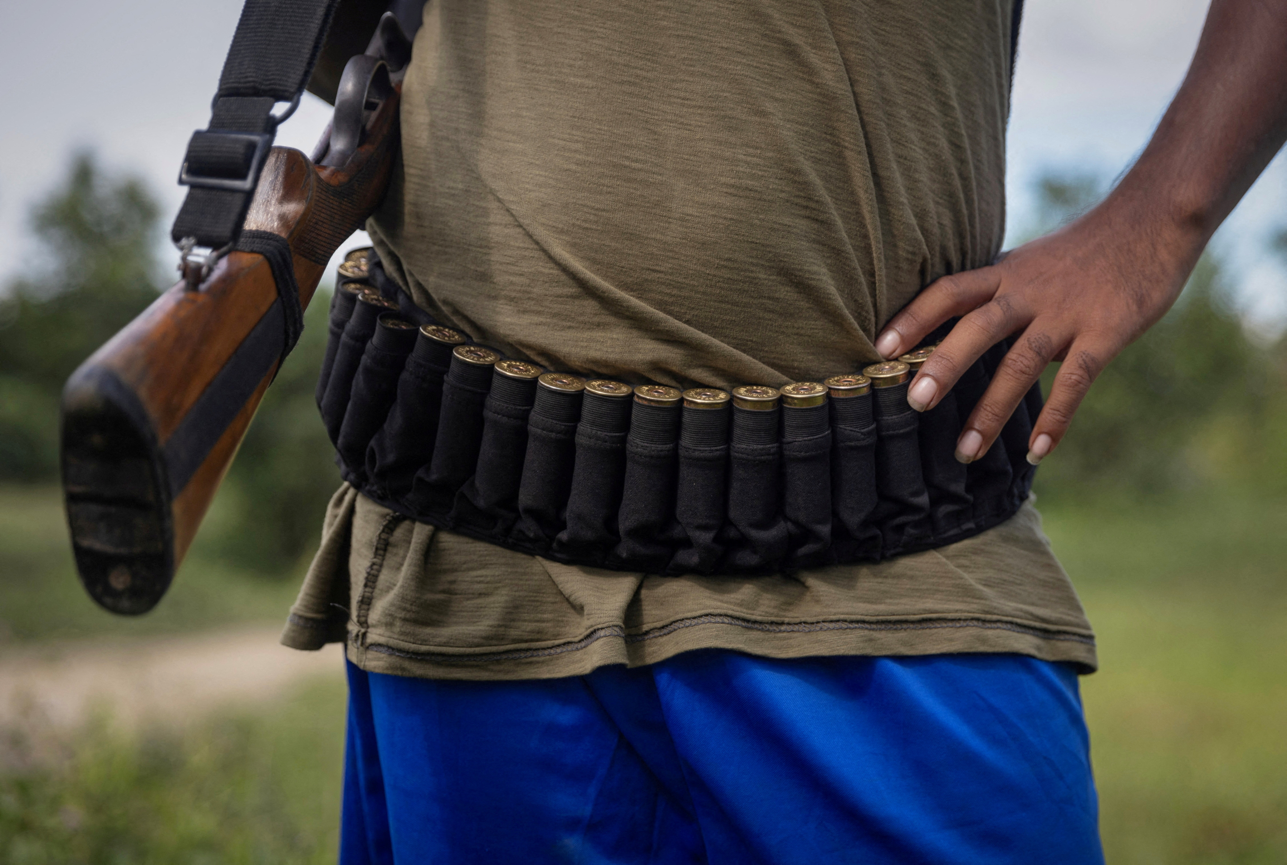 FILE PHOTO: An armed Kuki man stands at a checkpoint at Kangvai village in Churachandpur district