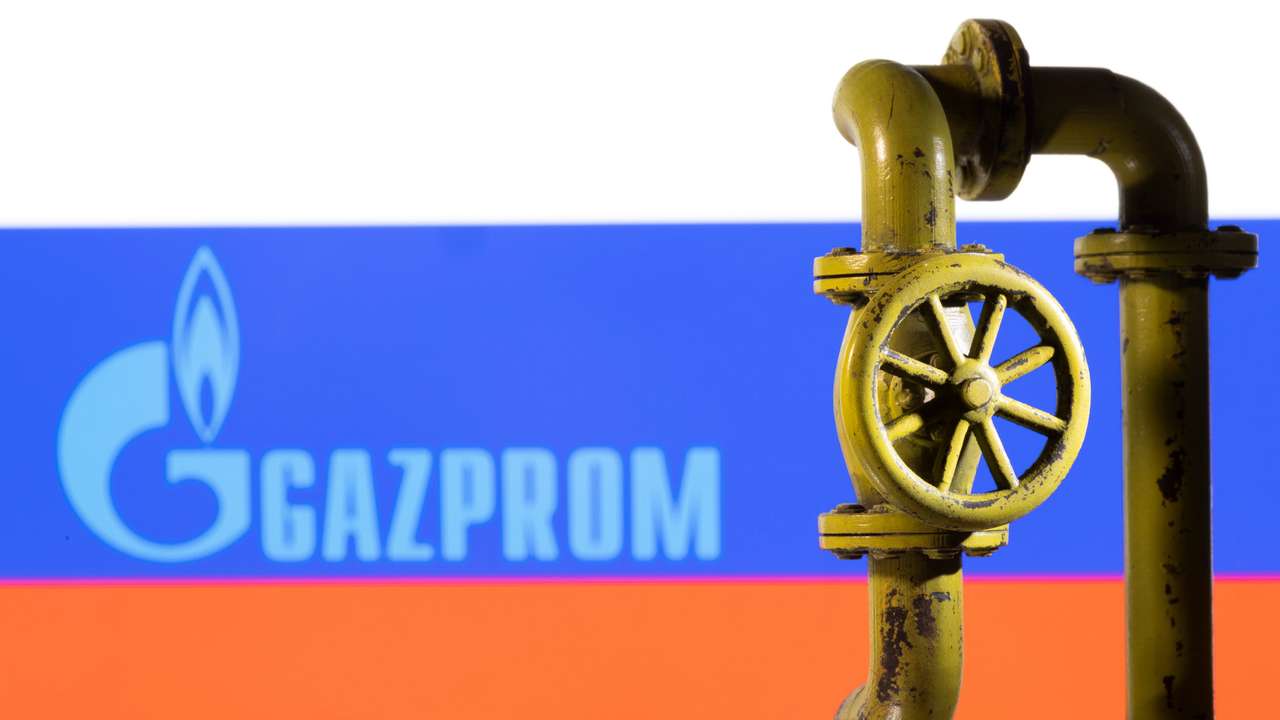 Illustration shows Gazprom logo and Russian flag