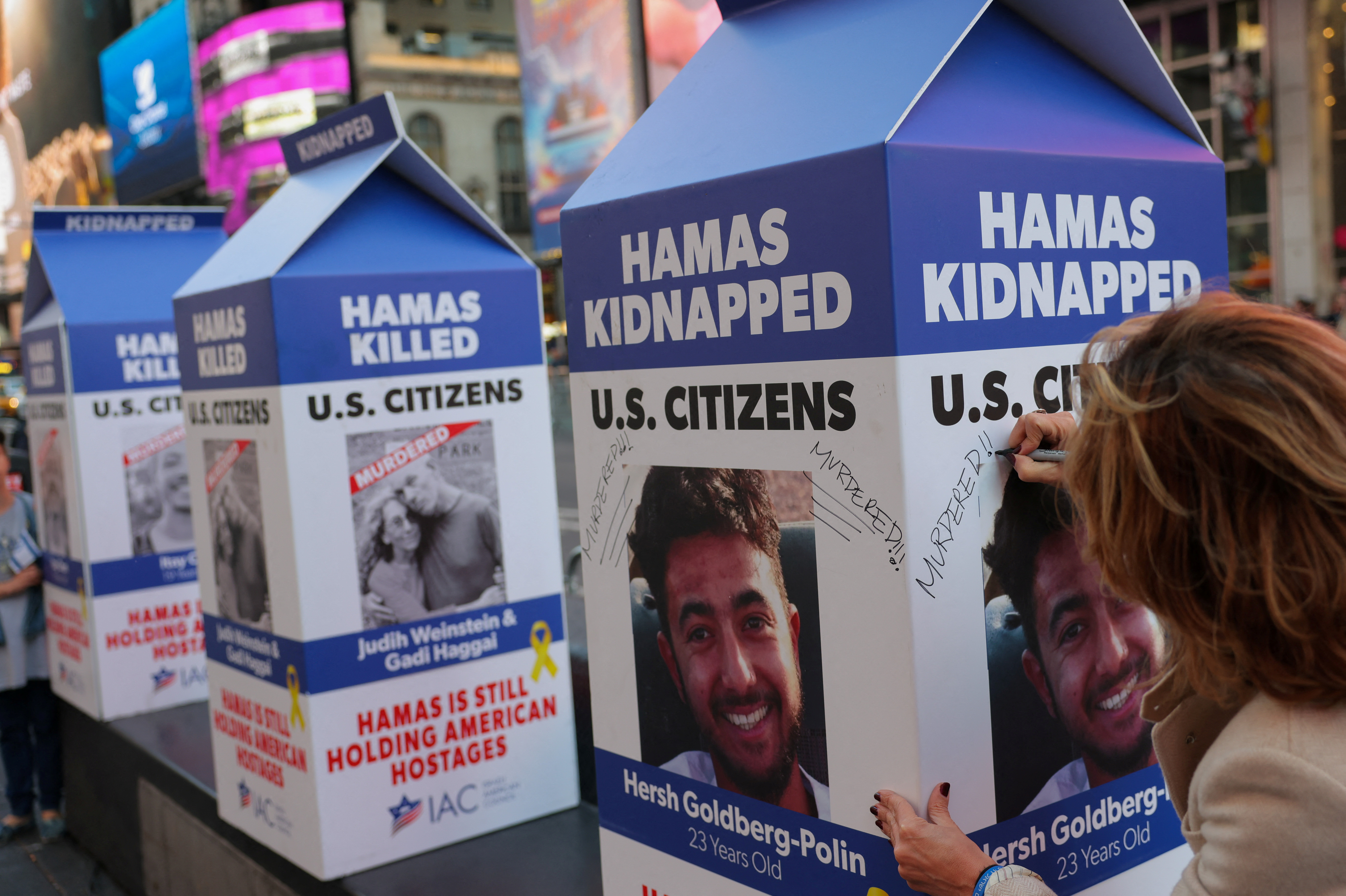 A person writes 'Murdered!' on a mock milk carton with the face of U.S. citizen Hersh Goldberg-Polin, who was kidnapped in the October 7 attack in Israel, in New York City