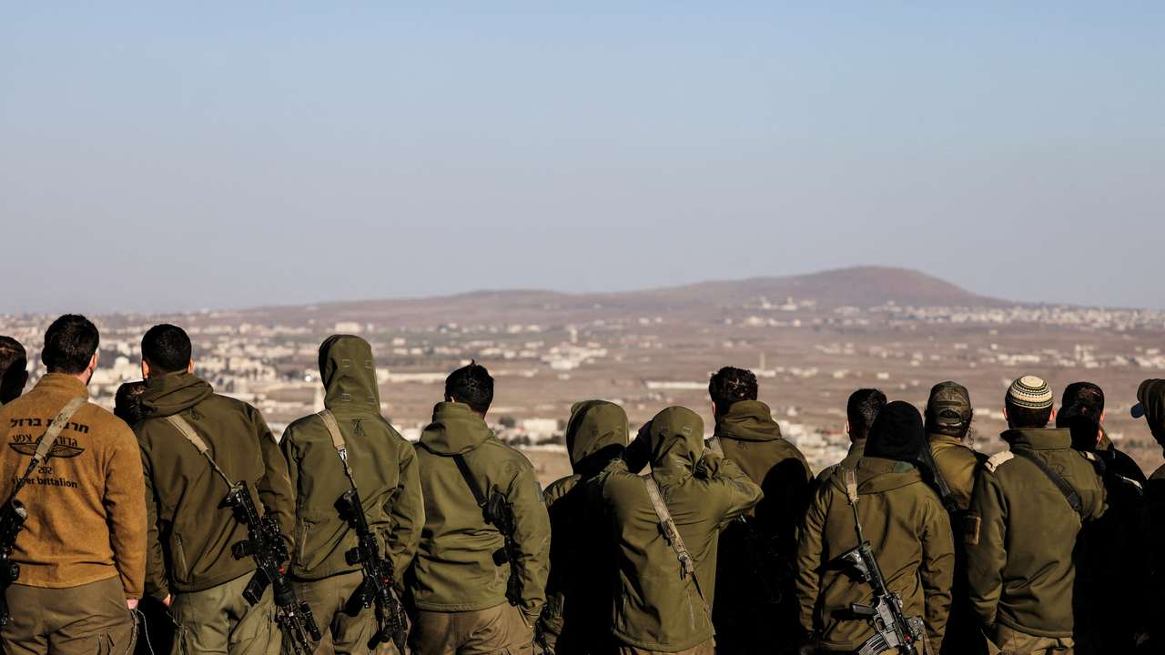 FILE PHOTO: Israeli soldiers look into Syria, after the ousting of Syria's Bashar al-Assad, in Ein Zivan in the Israeli-occupied Golan Heights