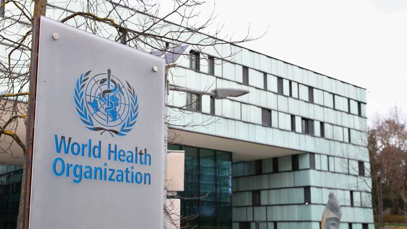 A logo is pictured outside a building of the WHO in Geneva