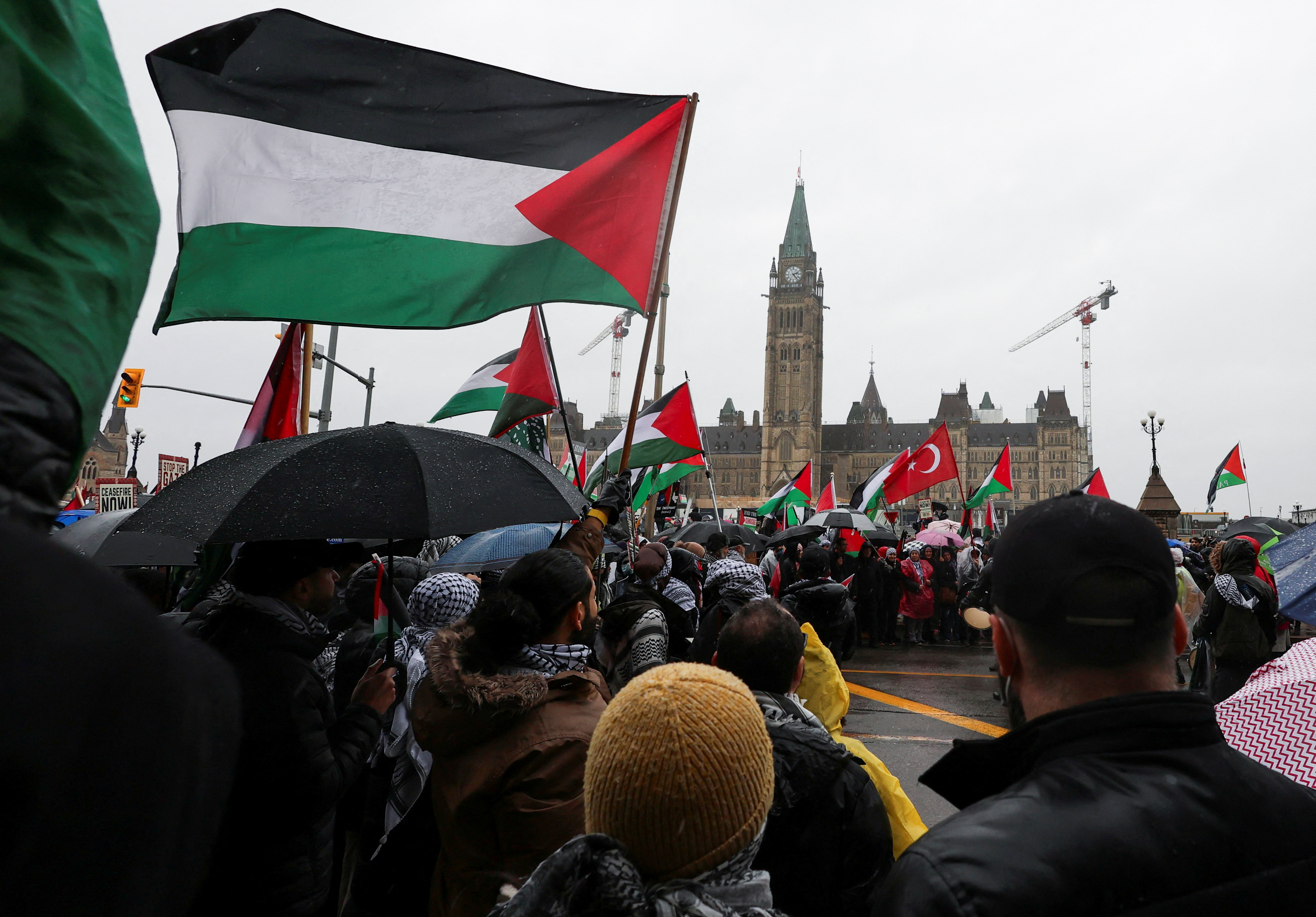 FILE PHOTO: Protesters hold Palestinian flags during a rally to call for a ceasefire in Ottawa