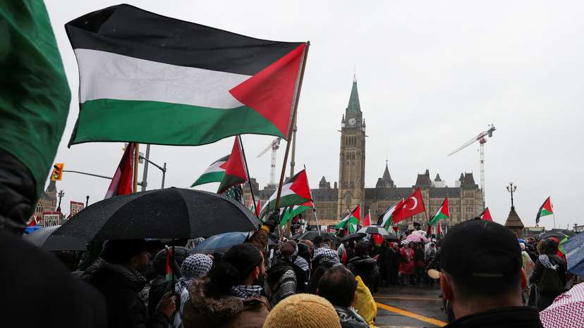 FILE PHOTO: Protesters hold Palestinian flags during a rally to call for a ceasefire in Ottawa