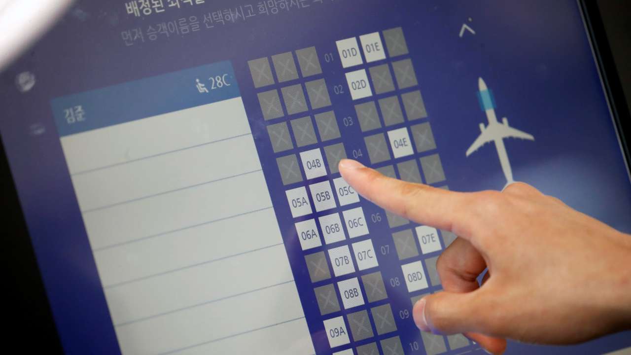 FILE PHOTO: A man checks his seat at Gimpo international airport in Seoul