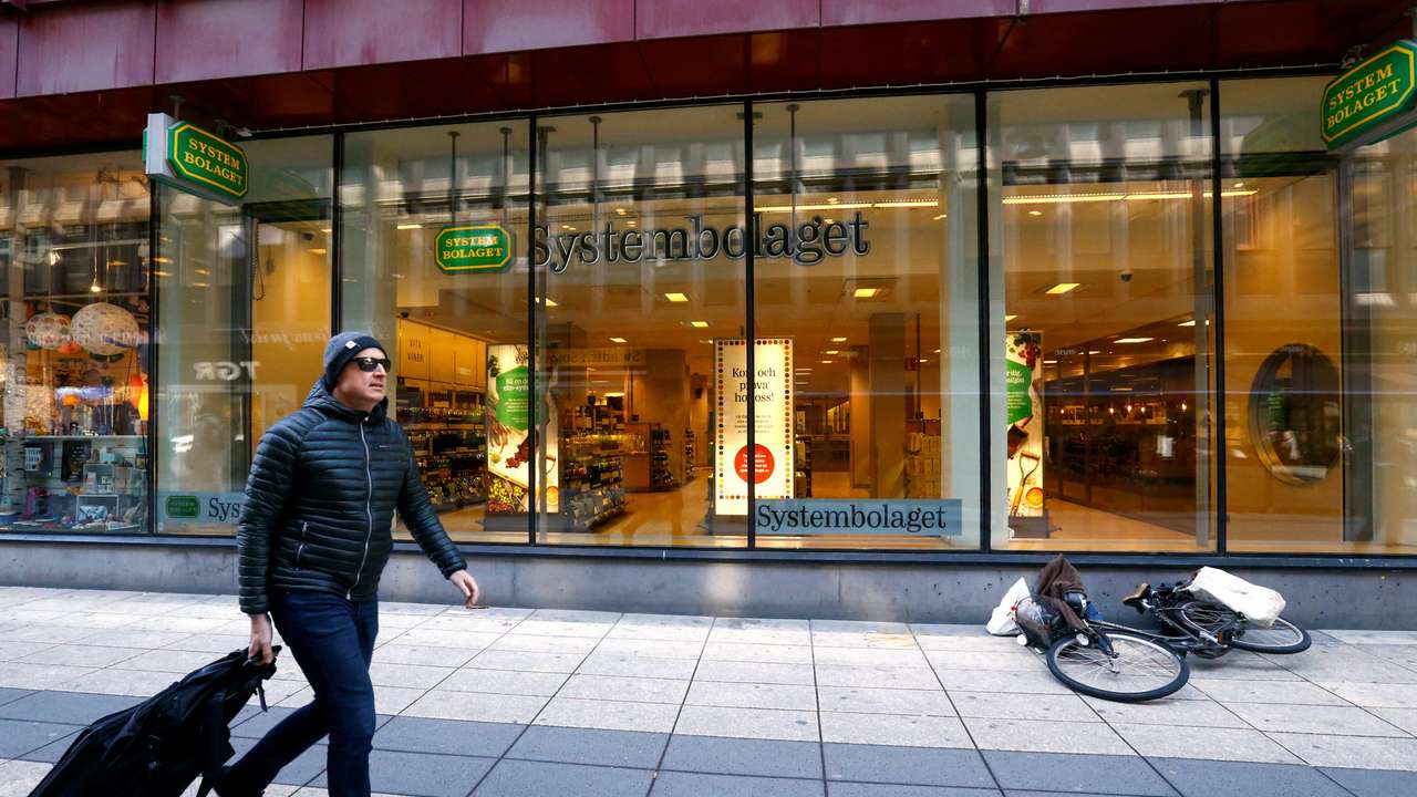 FILE PHOTO: A man walks past Systembolaget in Stockholm