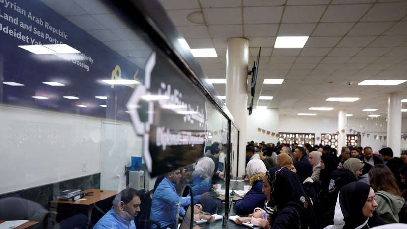 Syrians living in Lebanon wait at the Ministry of Interior Immigration and Passports Department, at the Syrian-Lebanese border, in Jdeidet Yabous