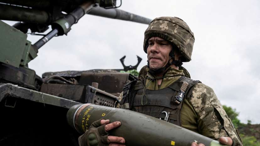 FILE PHOTO: Ukrainian service member carries a shell for a Caesar self-propelled howitzer before firing towards Russian troops near Avdiivka