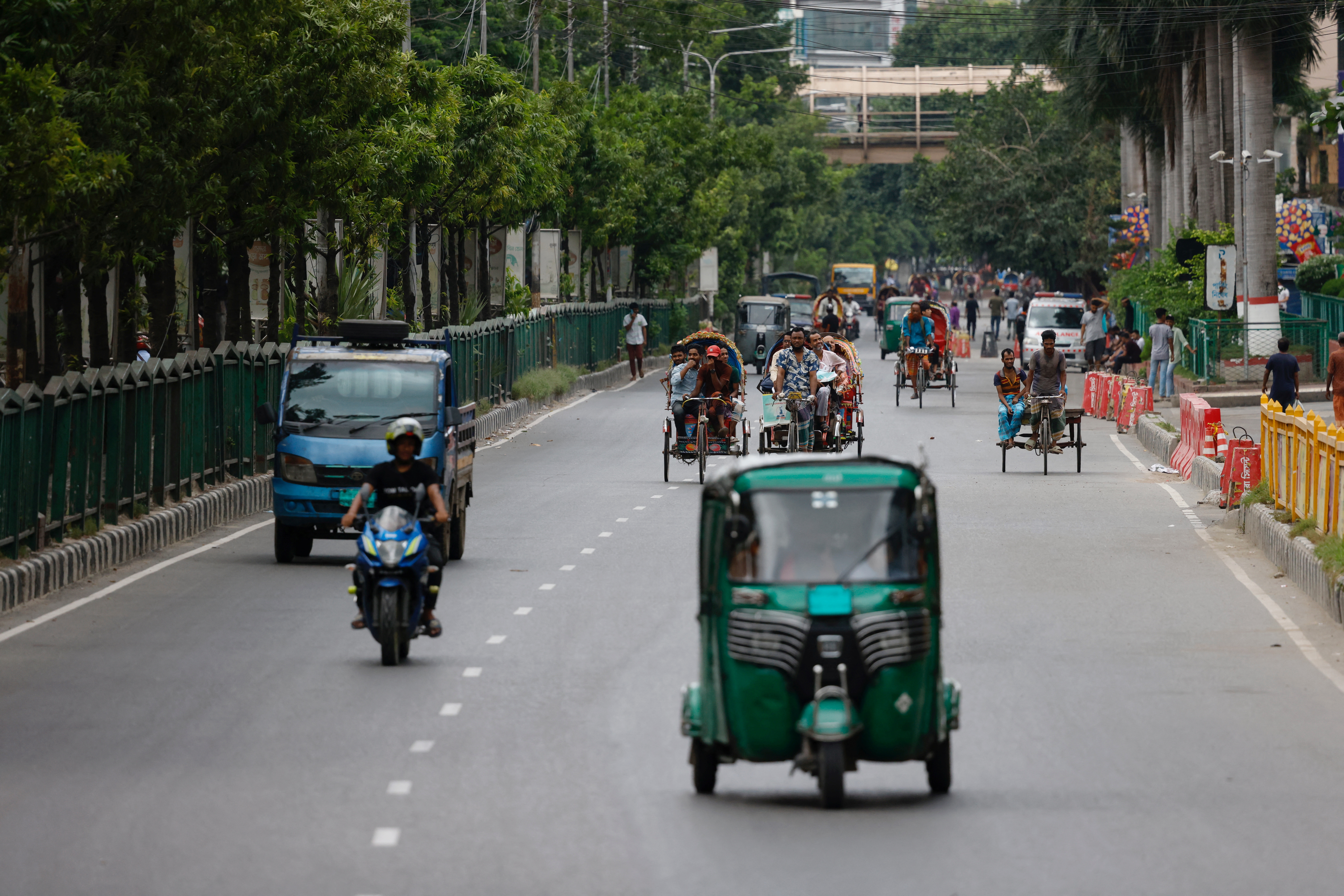 Limited vehicles move on a street on the second-day of curfew, in Dhaka