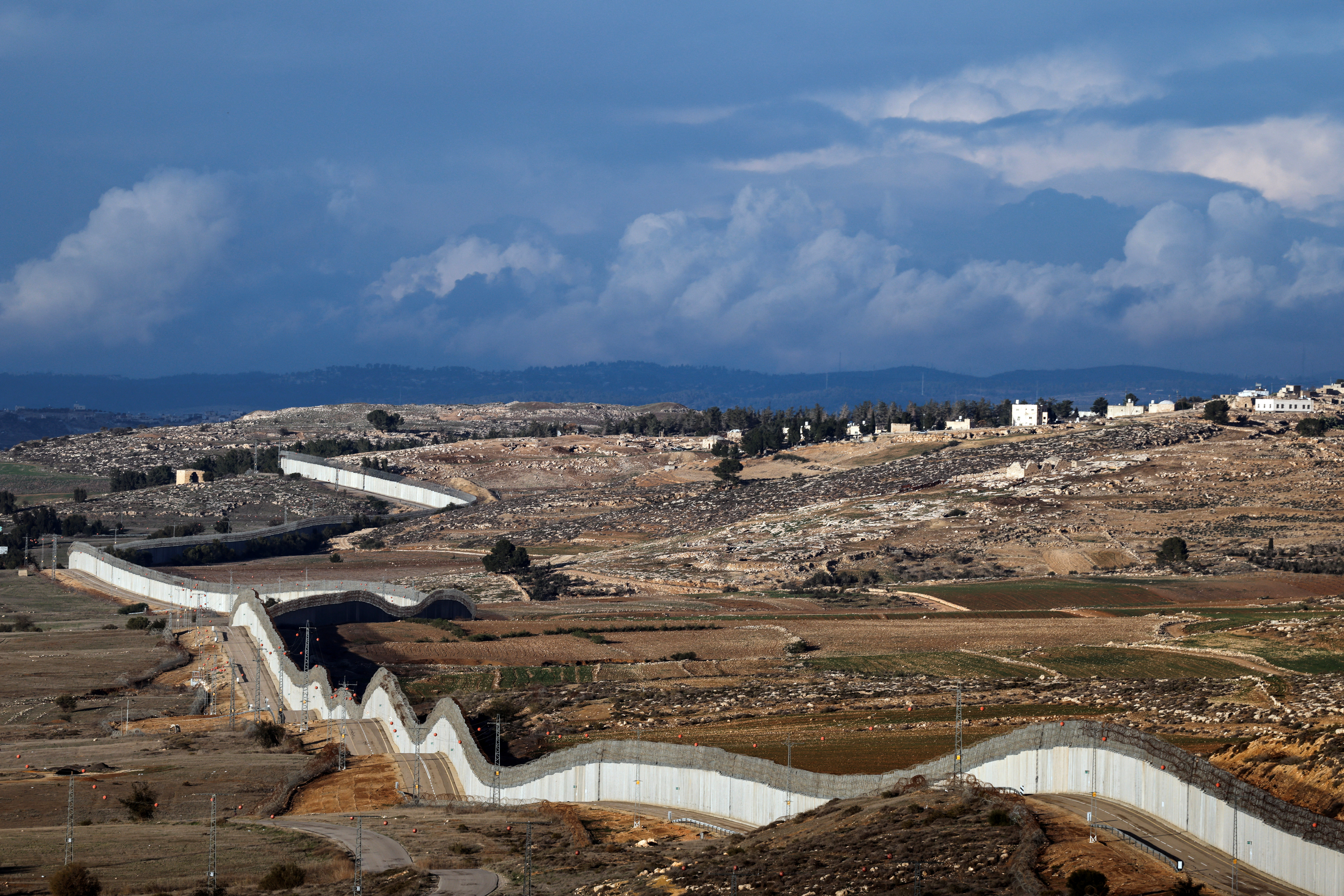 A view of the southern part of the Israeli-occupied West Bank, and the concrete barrier wall separating Israel and the West Bank, as seen from near Kibbutz Lahav