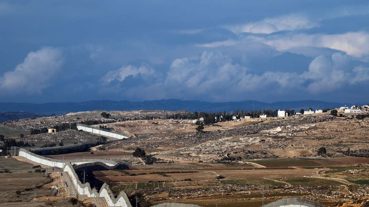 A view of the southern part of the Israeli-occupied West Bank, and the concrete barrier wall separating Israel and the West Bank, as seen from near Kibbutz Lahav