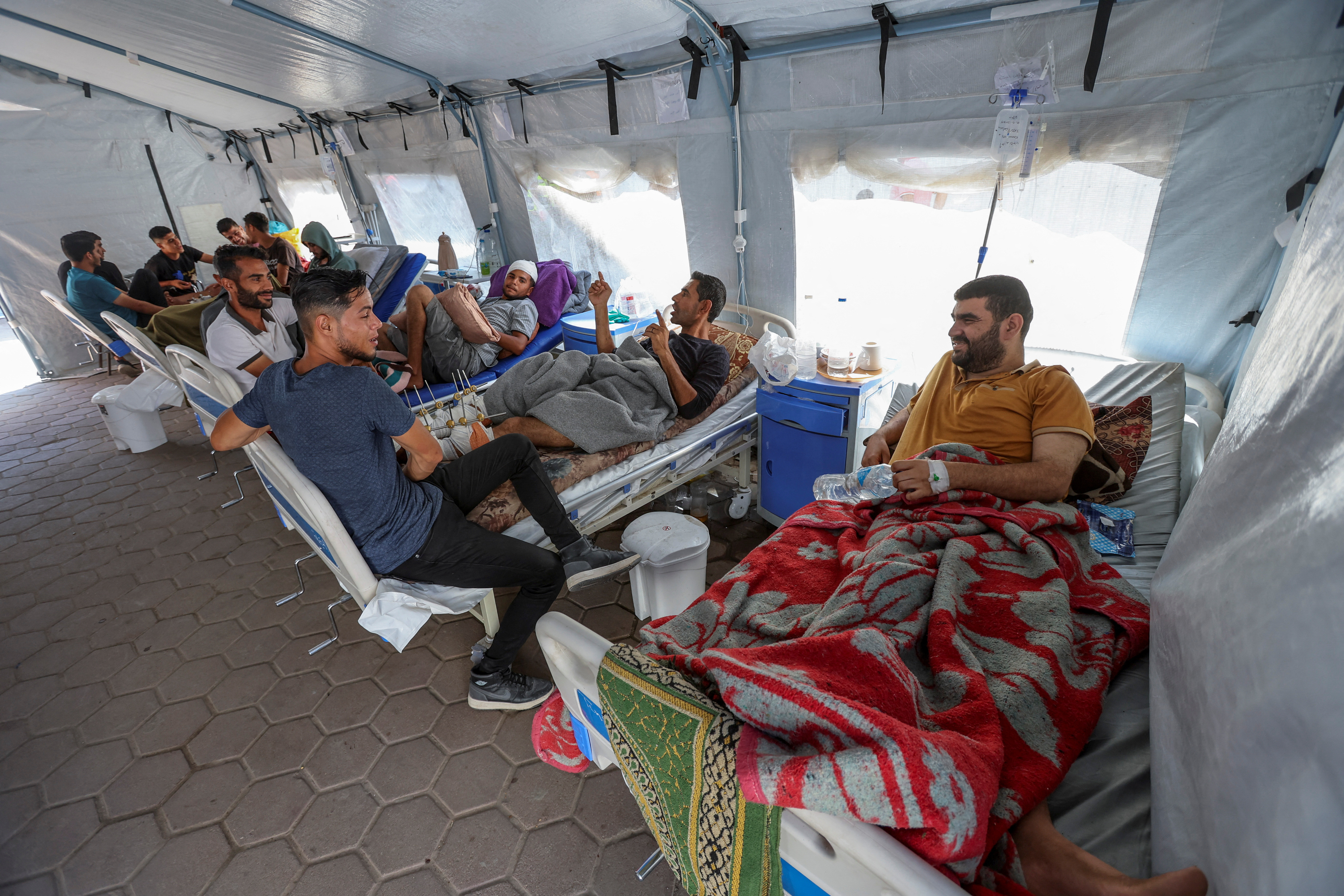 Palestinians wounded in Israeli fire lie on beds as they receive treatment at Al-Aqsa hospital in Deir Al-Balah in the central Gaza Strip
