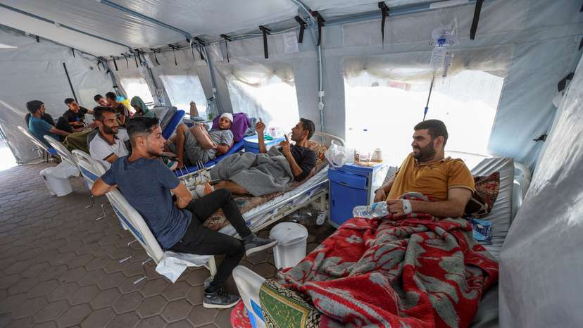 Palestinians wounded in Israeli fire lie on beds as they receive treatment at Al-Aqsa hospital in Deir Al-Balah in the central Gaza Strip