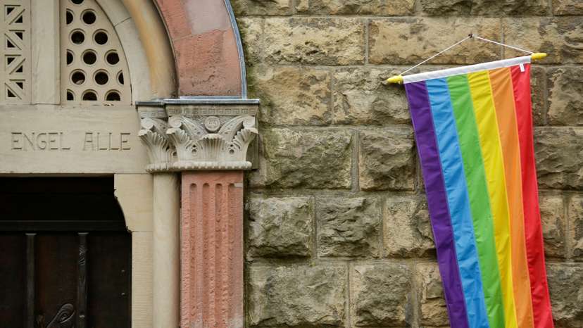 FILE PHOTO: A rainbow flag is seen on the wall of a Catholic church in Cologne