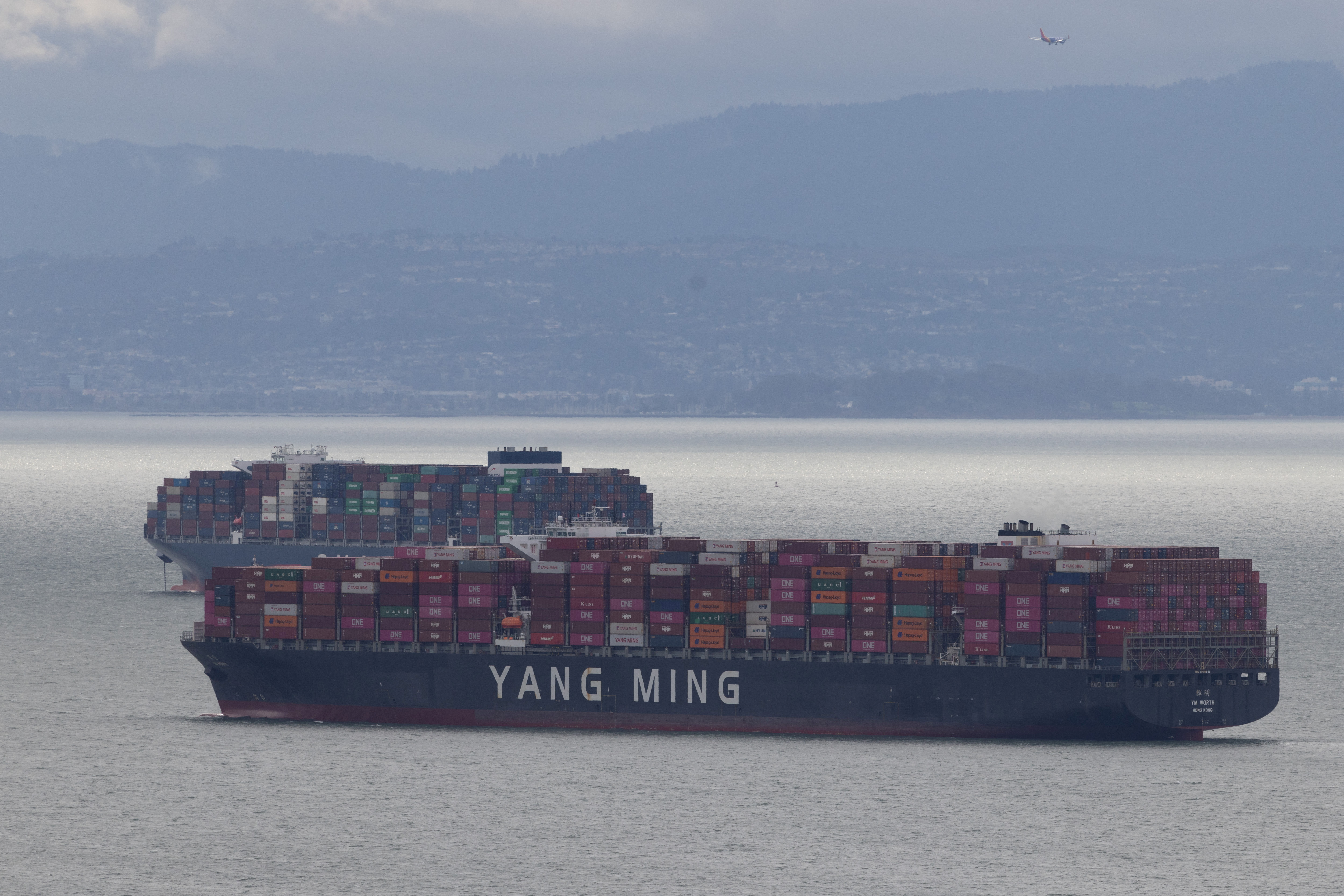 FILE PHOTO: Cargo ships full of shipping containers are seen at the port of Oakland  as trade tensions escalate over U.S. tariffs