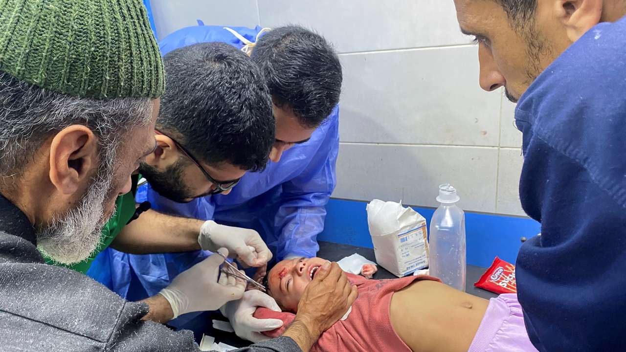 Palestinian girl Orheen Al-Dayah, who was injured on her forehead in an Israeli strike, has her wounds stitched without anaesthesia, at Al Shifa hospital in Gaza City