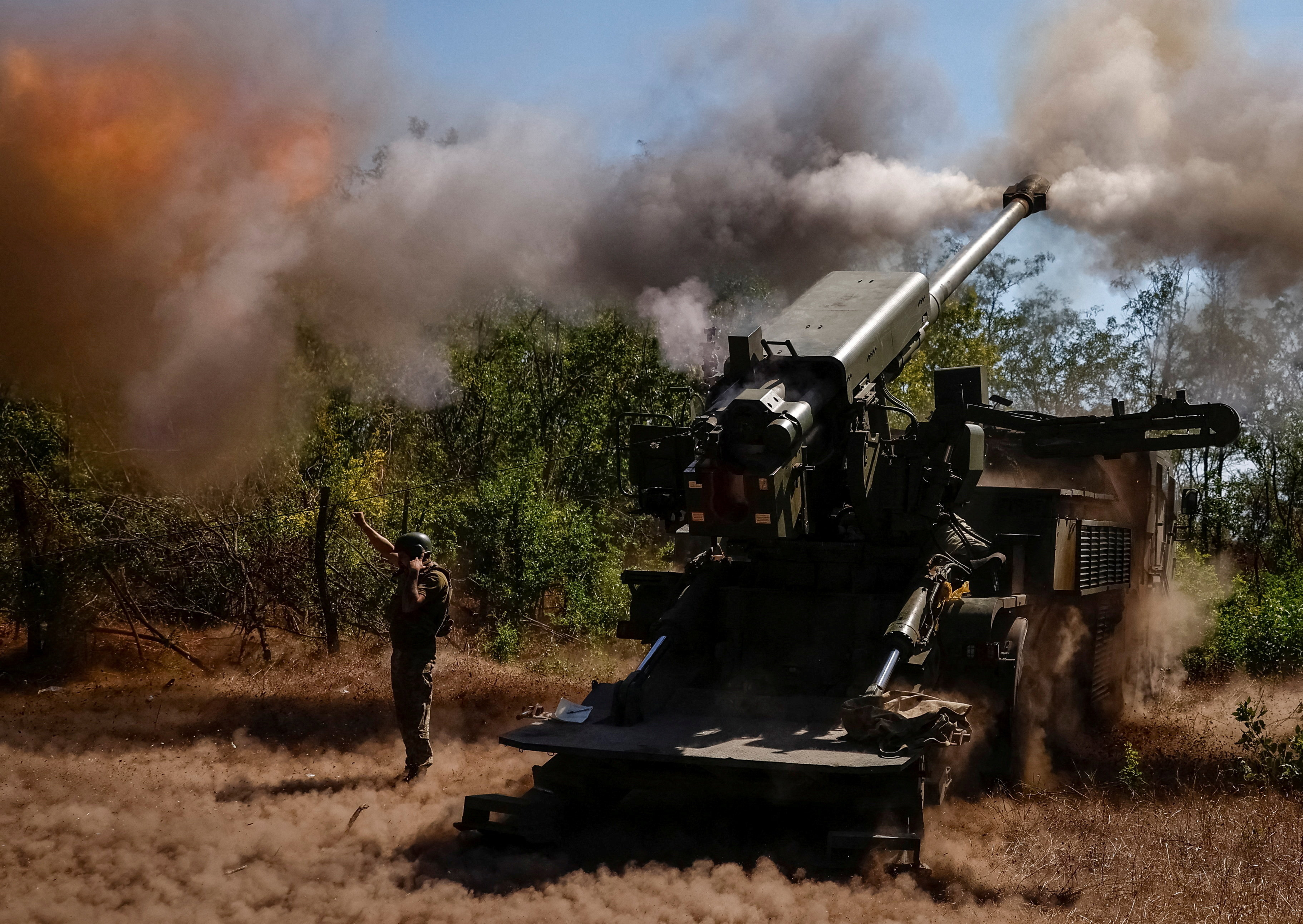 A Ukrainian serviceman fires a self-propelled howitzer towards Russian troops in Zaporizhzhia region