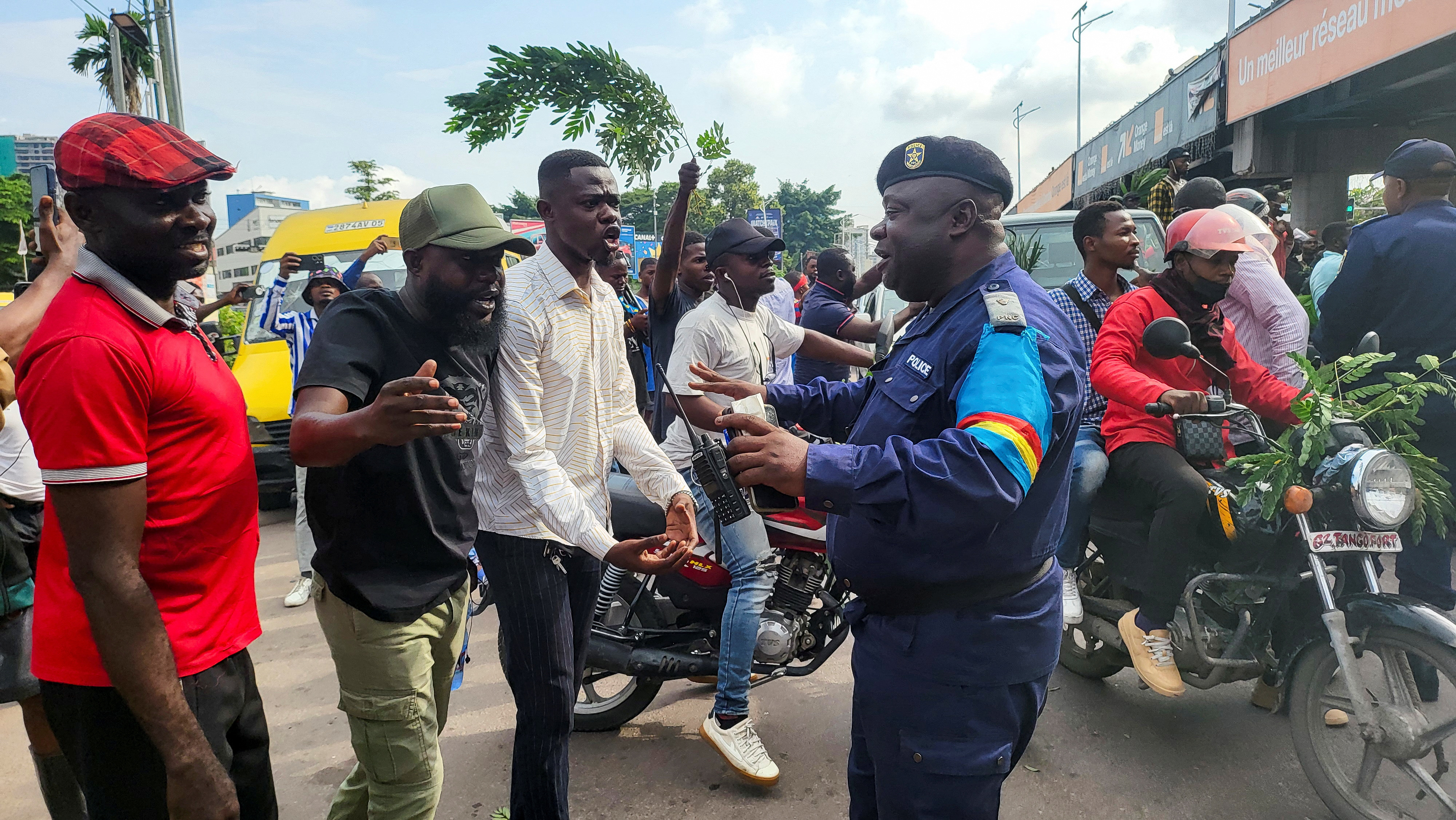 Protesters are stopped by security forces on a street in Kinshasa