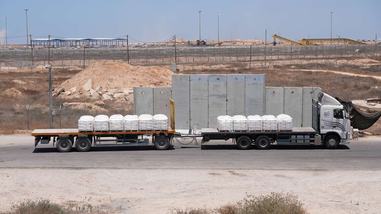 A truck carrying aid for delivery into Gaza drives through the Kerem Shalom crossing in southern Israel