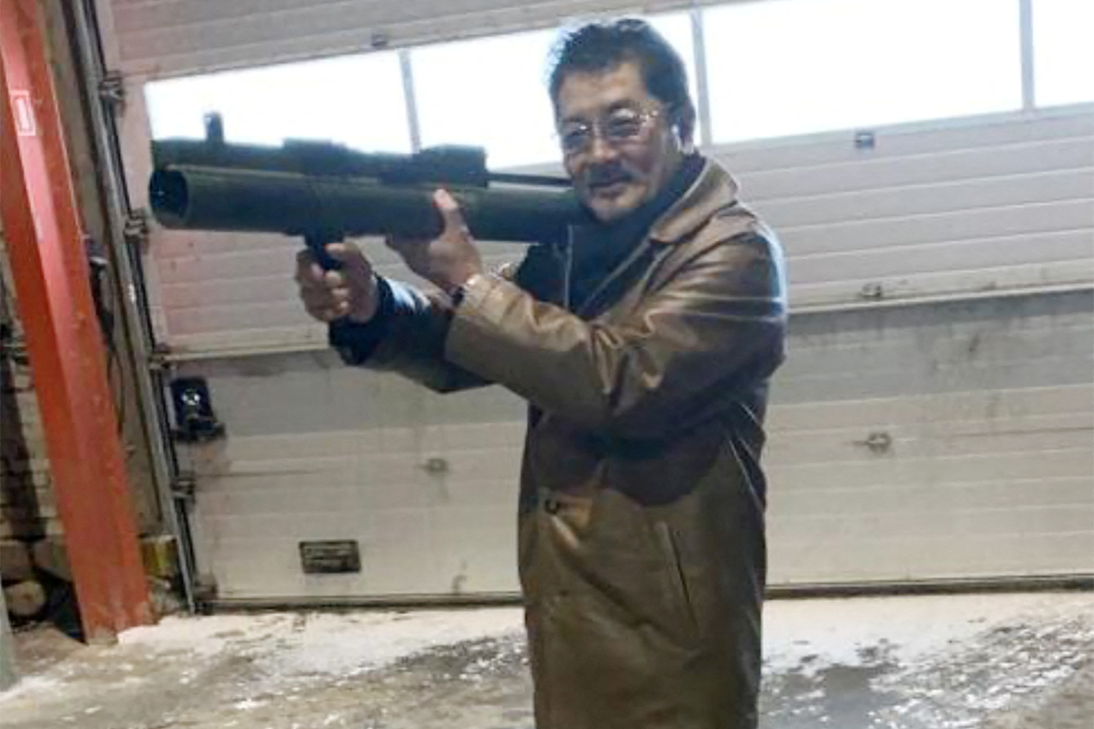 FILE PHOTO: Takeshi Ebisawa poses with a rocket launcher during a meeting with an informant at a warehouse in Copenhagen