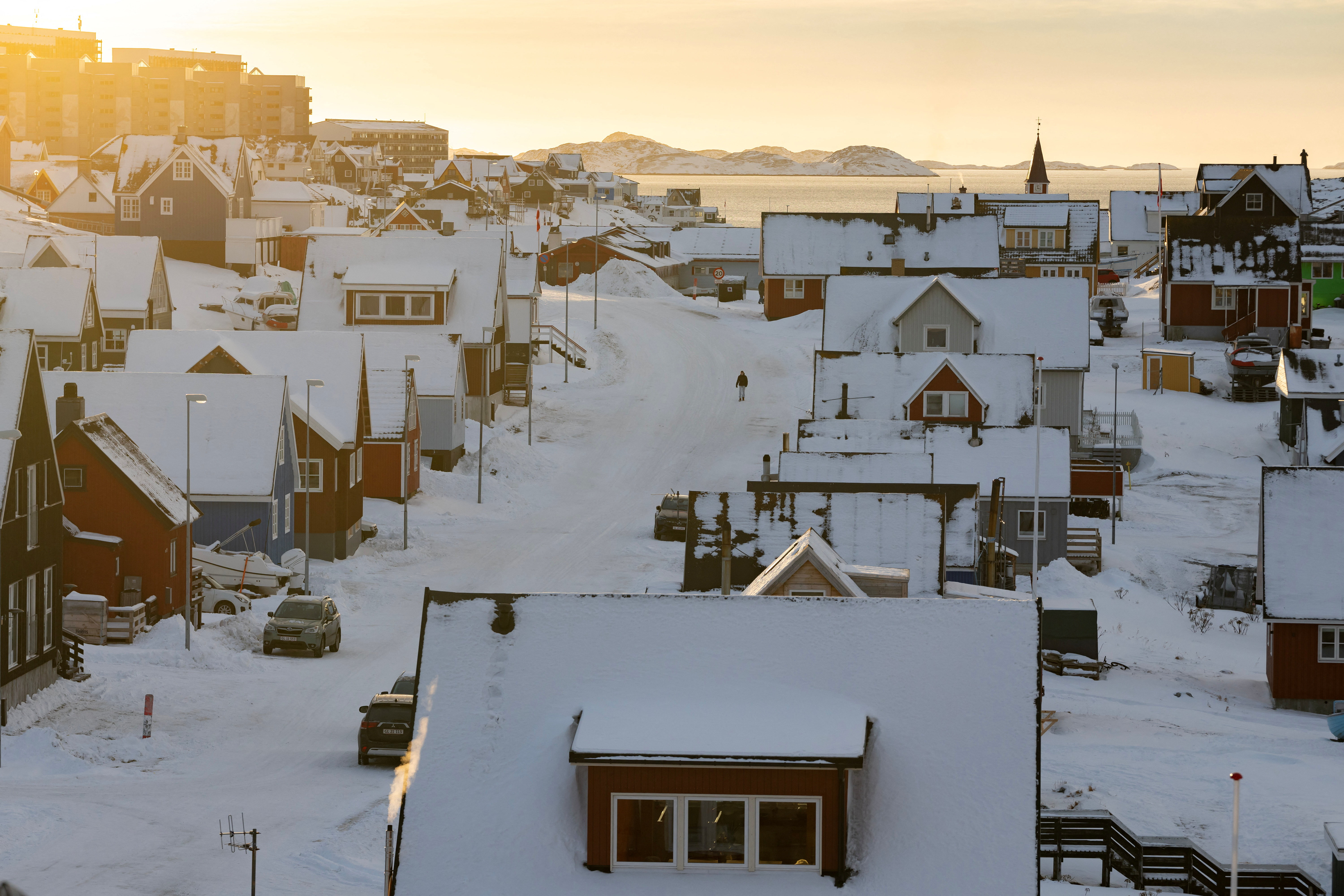 A person walks along a street on the day of the meeting between top U.S. officials and the foreign ministers of Denmark and Greenland, in Nuuk