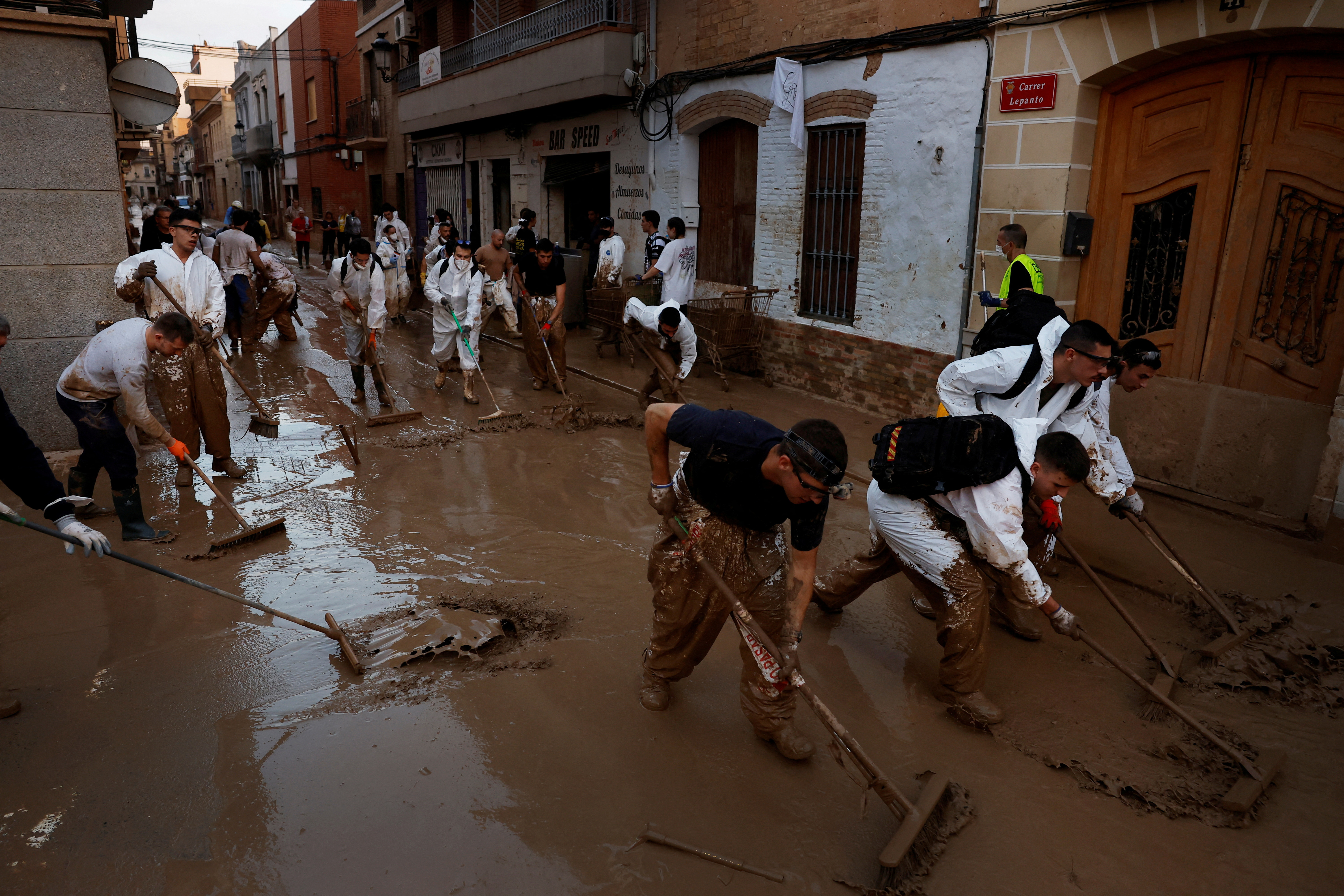 FILE PHOTO: Volunteers continue cleaning up following floods in Valencia