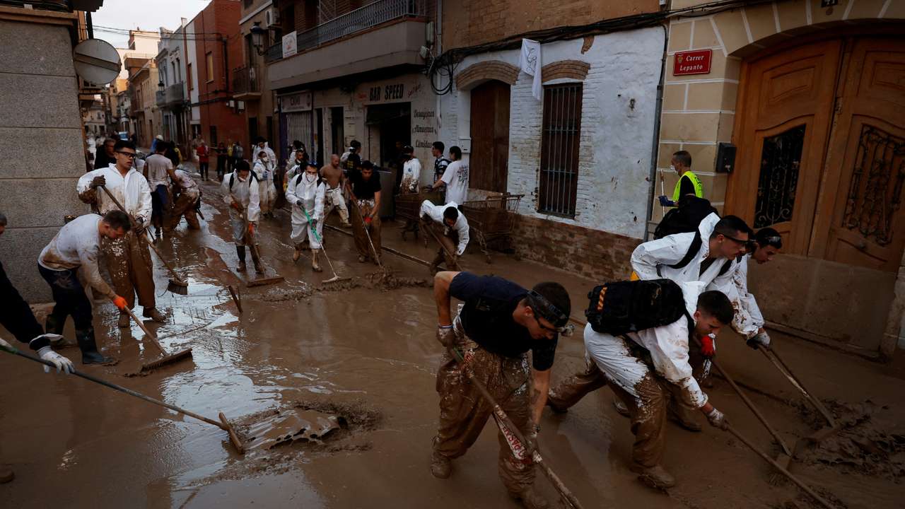 FILE PHOTO: Volunteers continue cleaning up following floods in Valencia