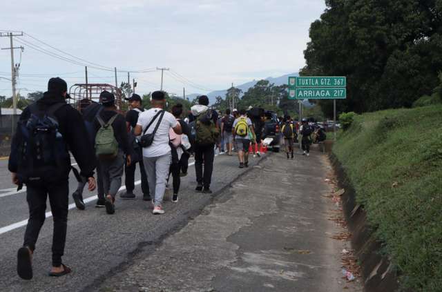 Migrants walk in a caravan in an attempt to reach the U.S. border, in Tapachula