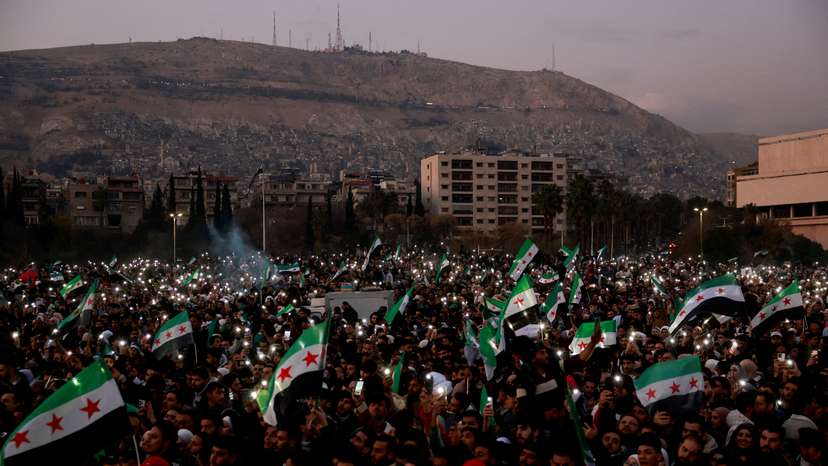 People gather during a celebration called by Hayat Tahrir al-Sham (HTS) after the ousting of Syria's Bashar al-Assad, in Damascus