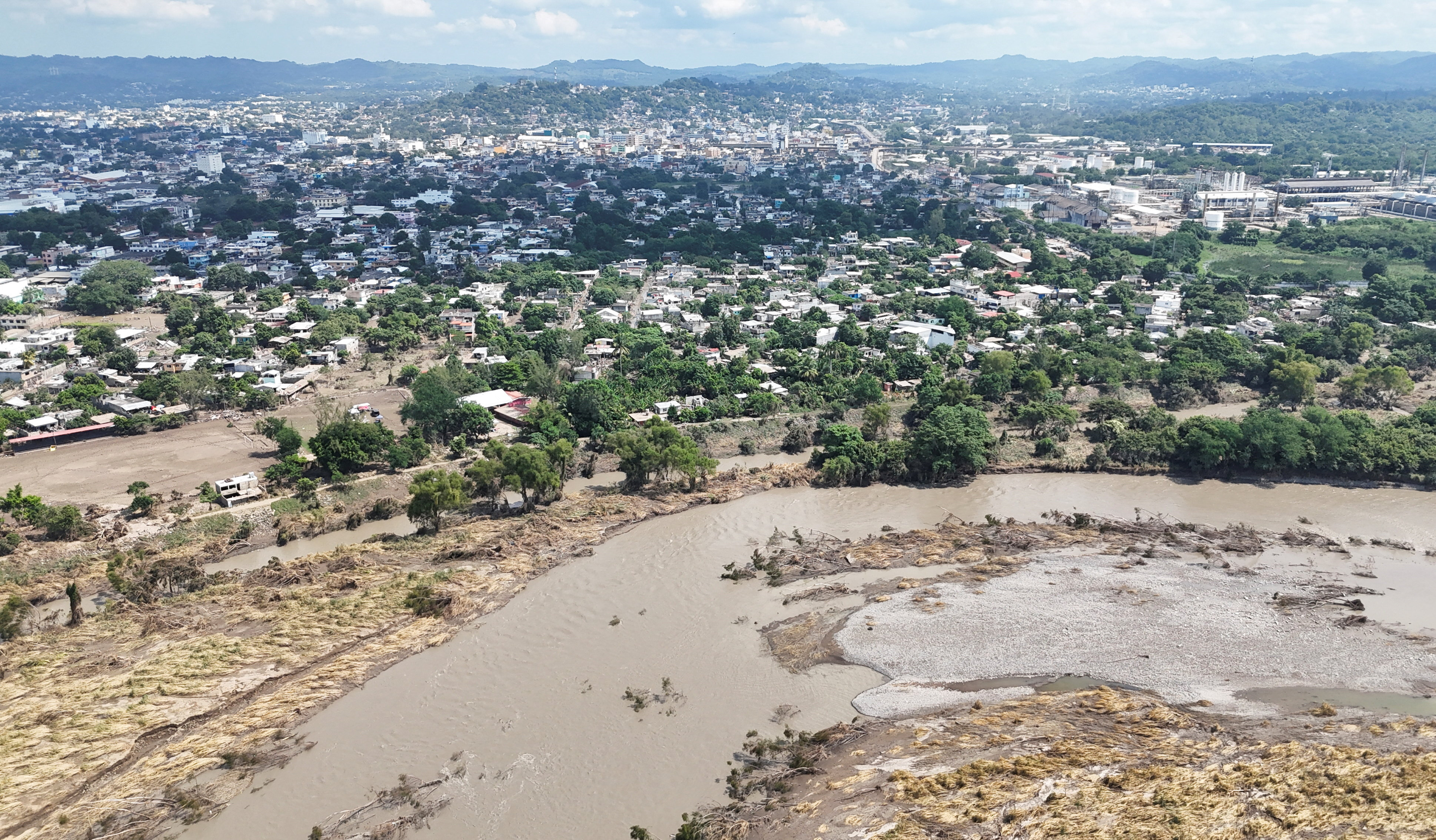 Drone view shows muddy floodwater after a river overflowed following torrential rains, in Mexico