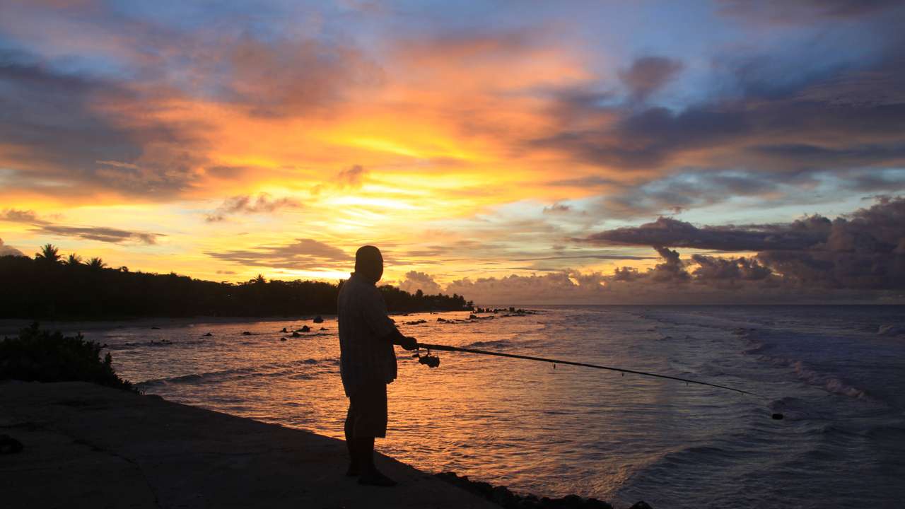 A fisherman is pictured at sunset at the northern end of the airport runway on the nation island of Nauru
