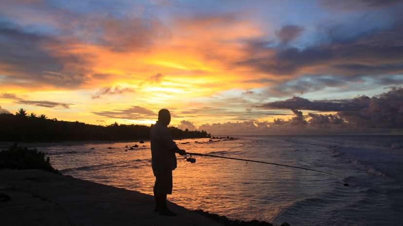 A fisherman is pictured at sunset at the northern end of the airport runway on the nation island of Nauru
