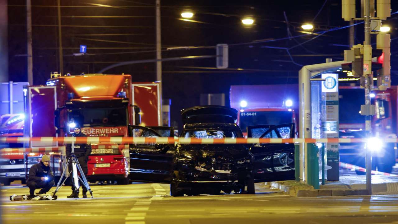 Emergency personnel stand next to a damaged car that drove into a group of people, according to local media, in Magdeburg