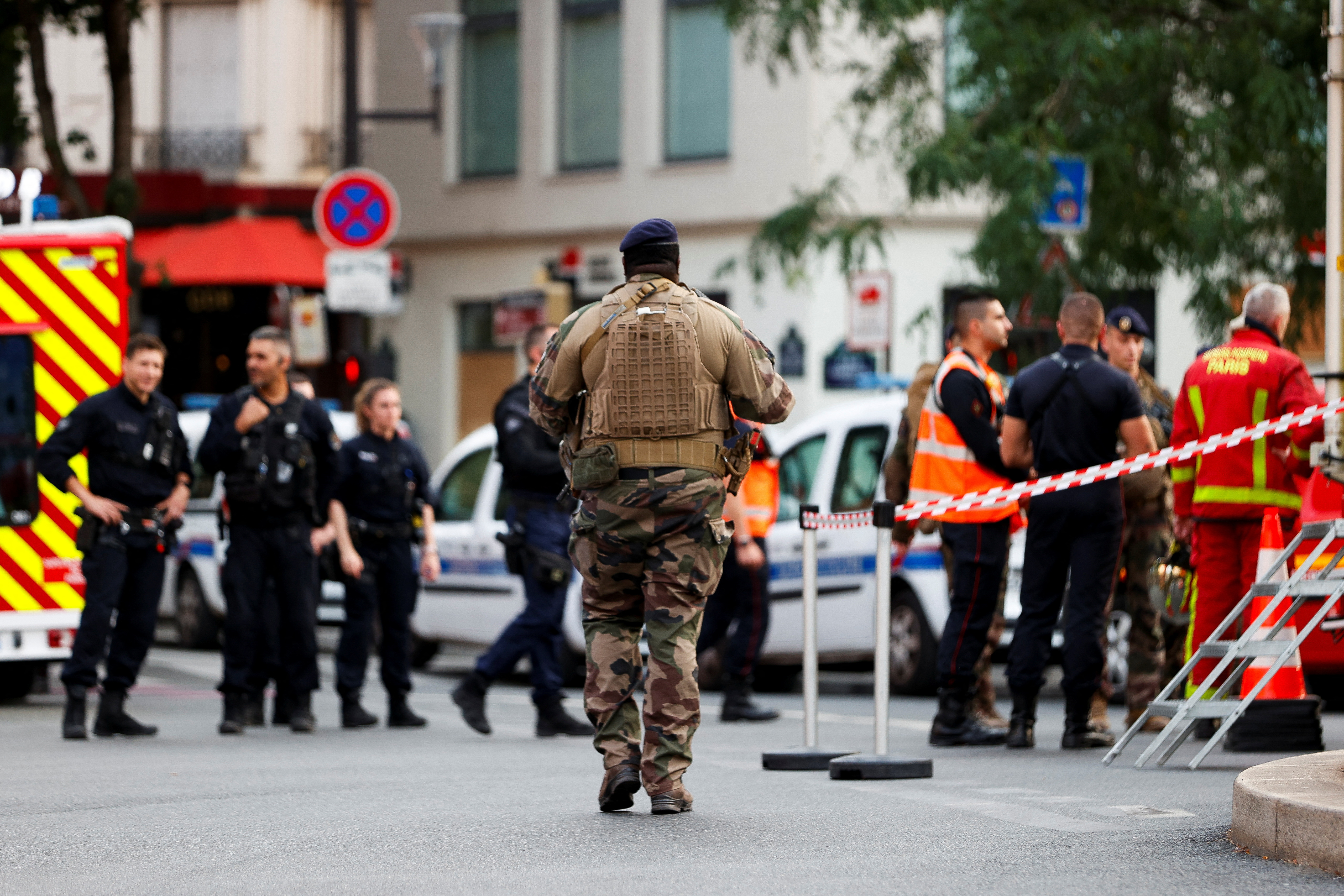 Rescue forces work at the scene after a car hit people sitting on a terrace in front of a restaurant in Paris
