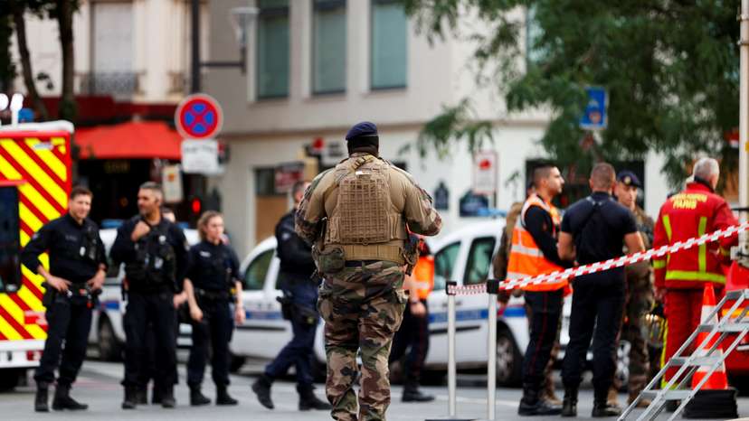 Rescue forces work at the scene after a car hit people sitting on a terrace in front of a restaurant in Paris